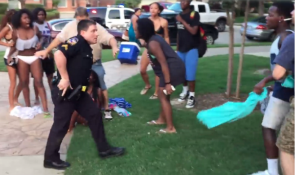 Police drawing gun at pool party