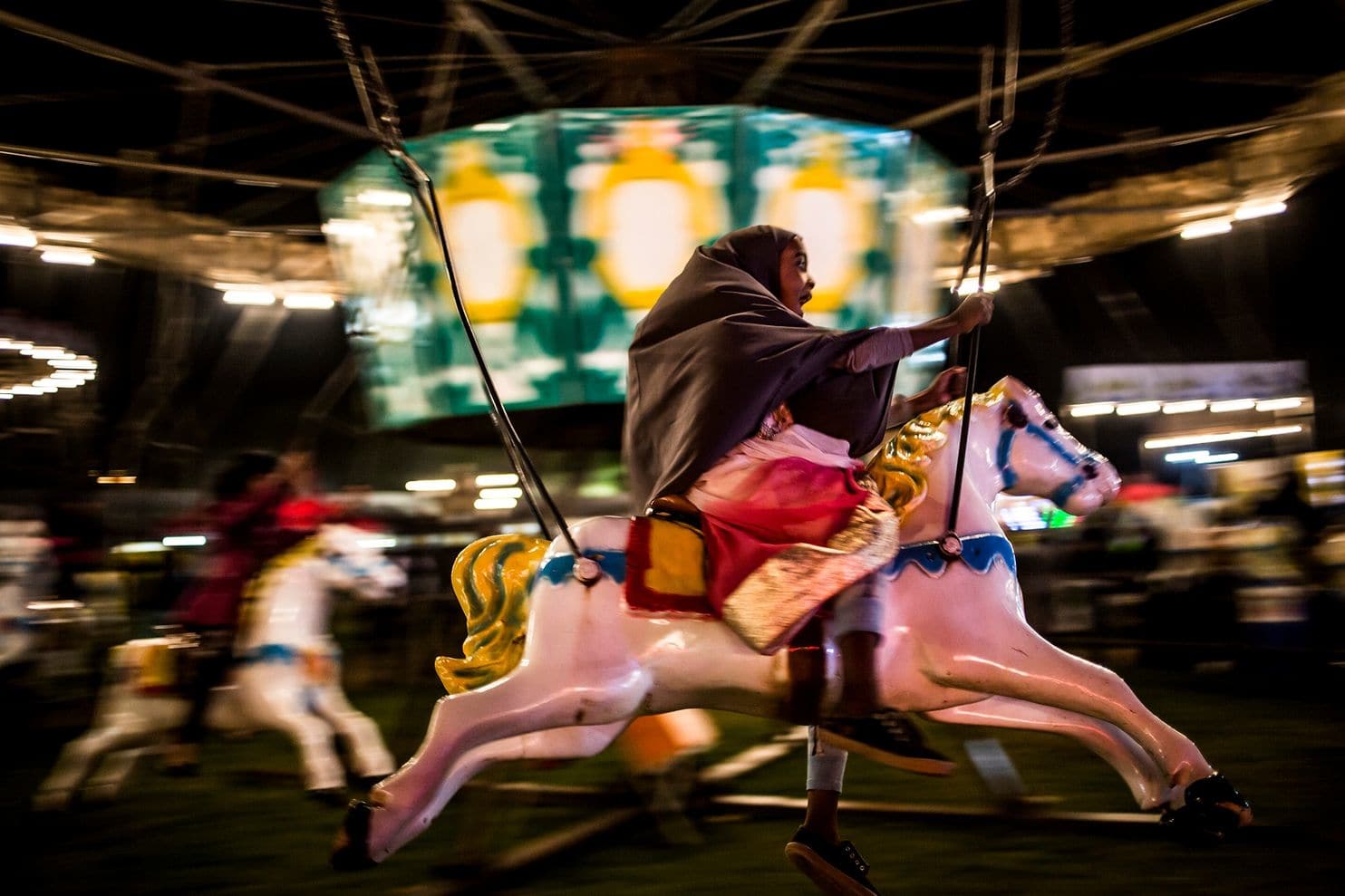 Khan’s focus is deeply anchored in news photography.