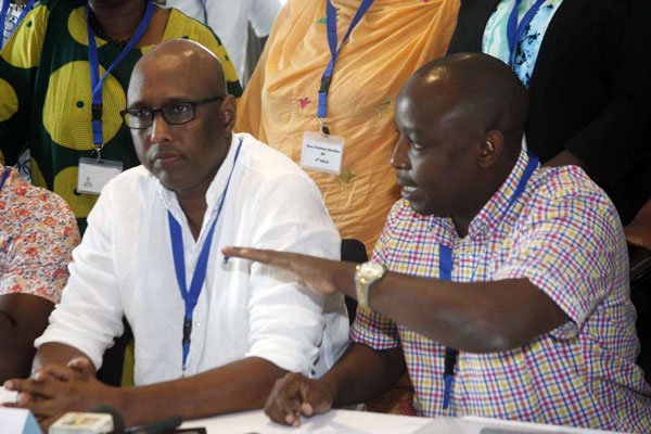 Adan Mohamed and Simon Mbugua address journalists